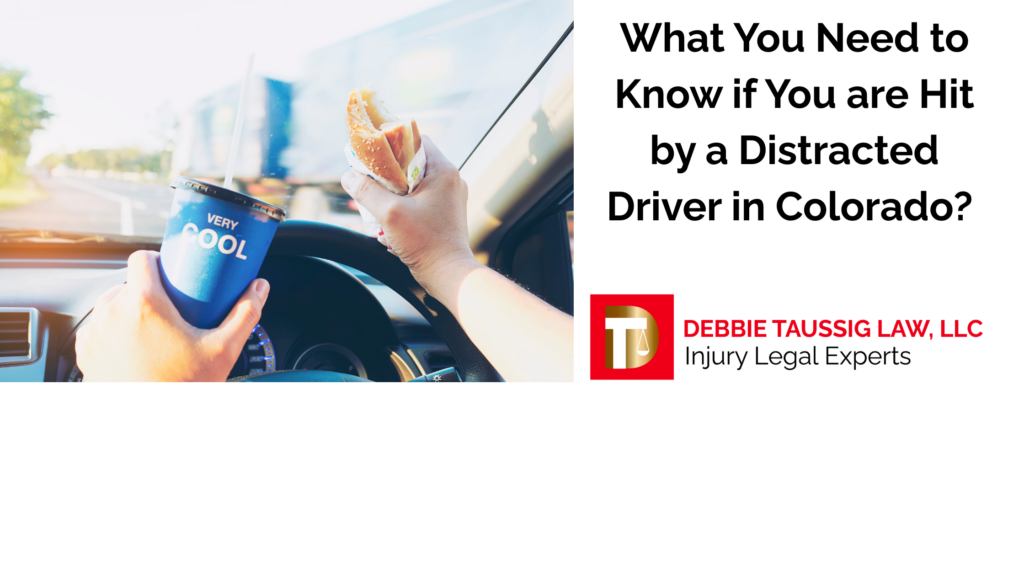 Driver distracted with drink and food in hands while driving.