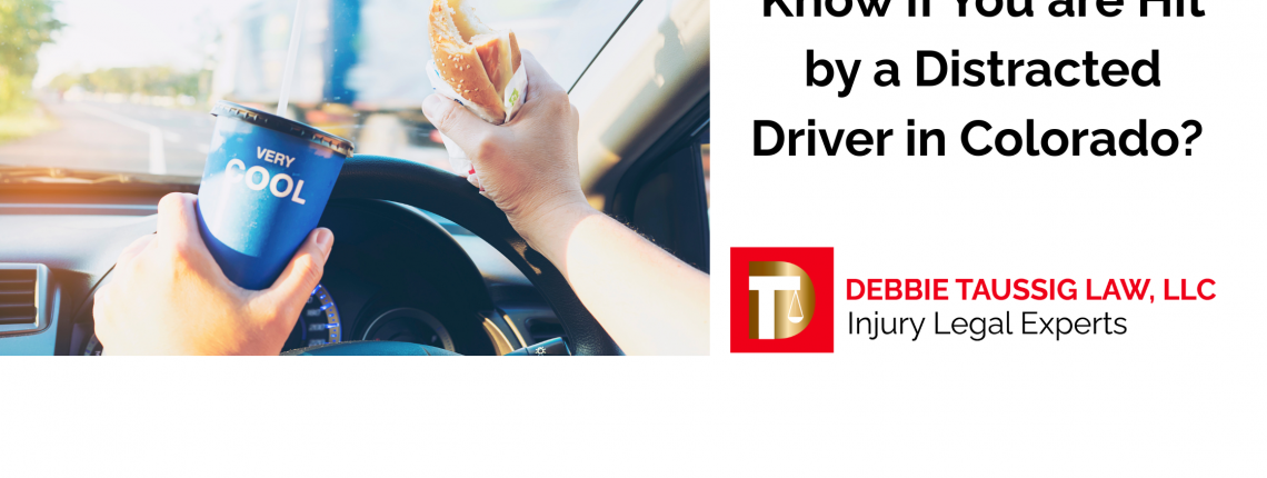 Driver distracted with drink and food in hands while driving.