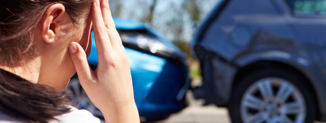 Stressed Driver Sitting At Roadside After Traffic Accident