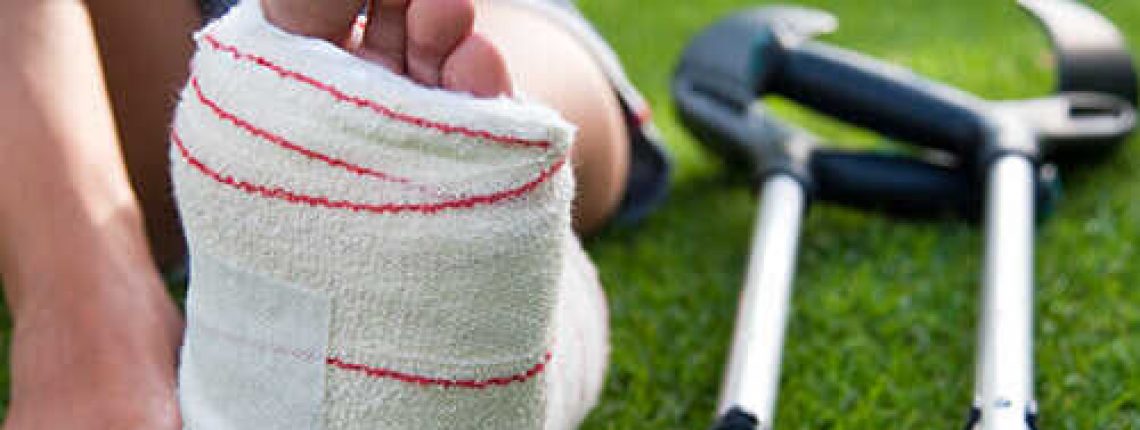 womans-foot-in-cast-next-to-crutches-on-the-grass-sm